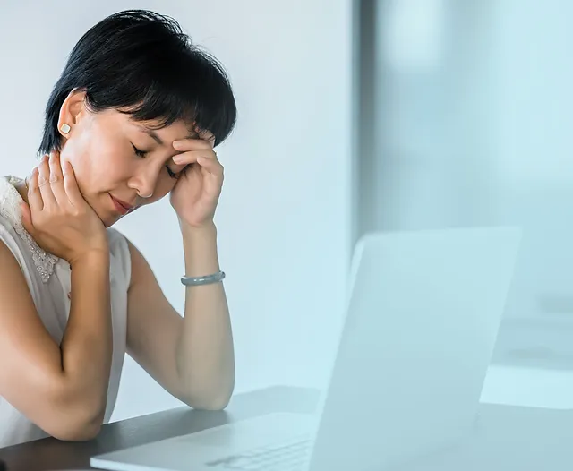 Woman appears tired at her desk